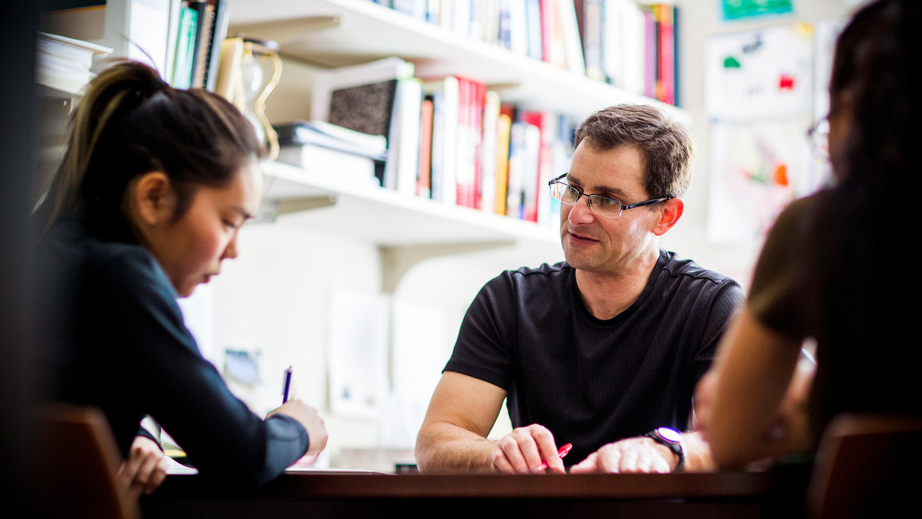 students meet with advisor in office