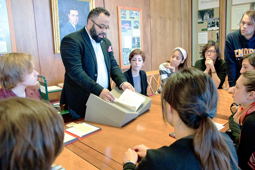 Professor sharing a rare book from the Rose Library