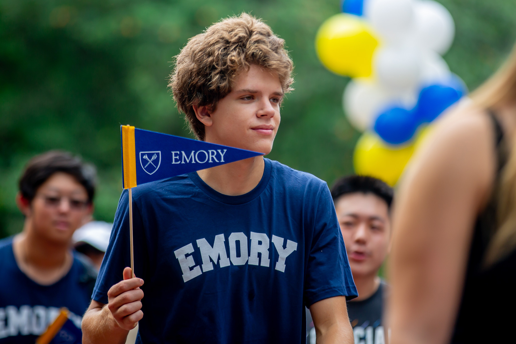 Students parading with Emory pennant