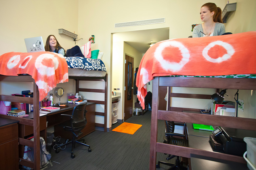 two Emory students study in their dorm room