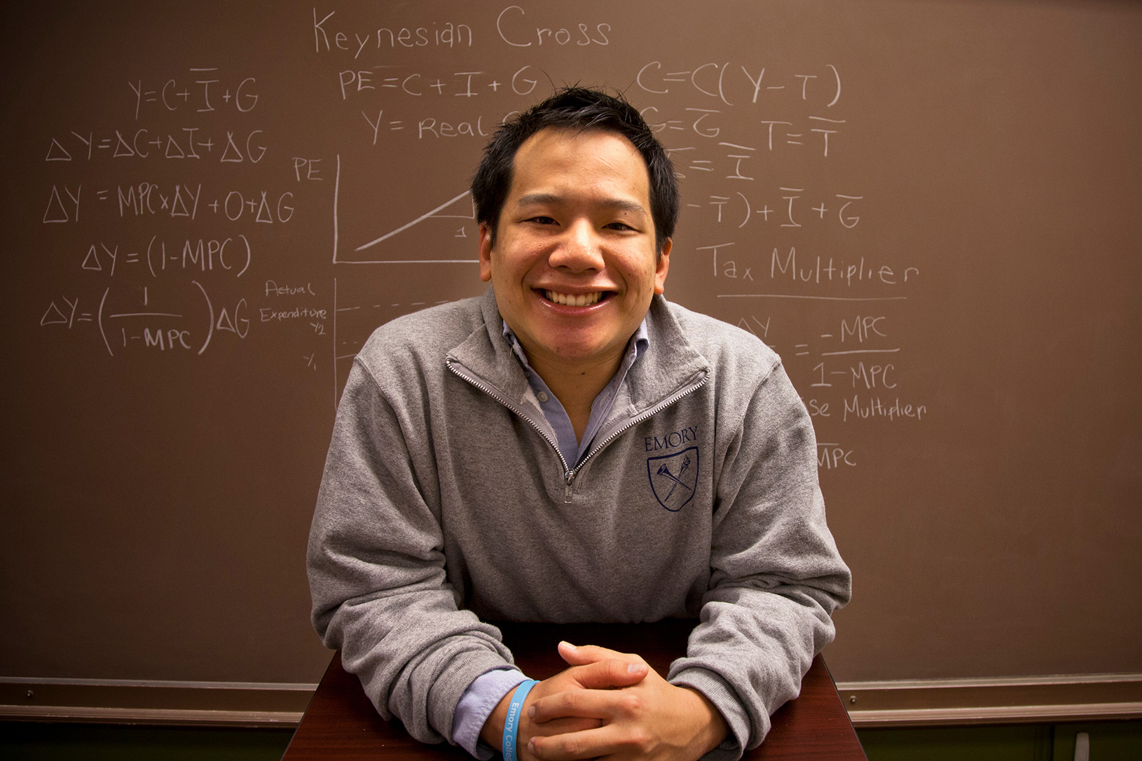 student in front of chalkboard