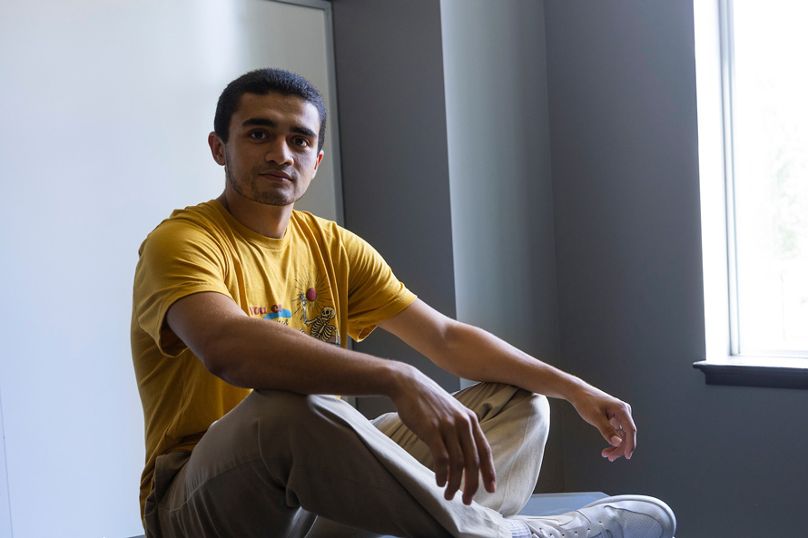 student Anthony Vargas 26Ox sits cross-legged